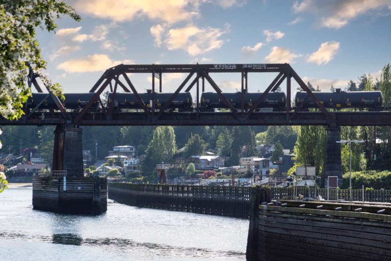 oil containers on an intermodal train crossing over river