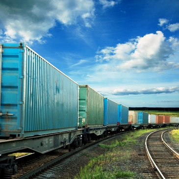 light blue intermodal containers on rail tracks