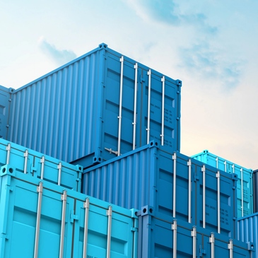 stack of light blue dark blue shipping containers stacked on one another