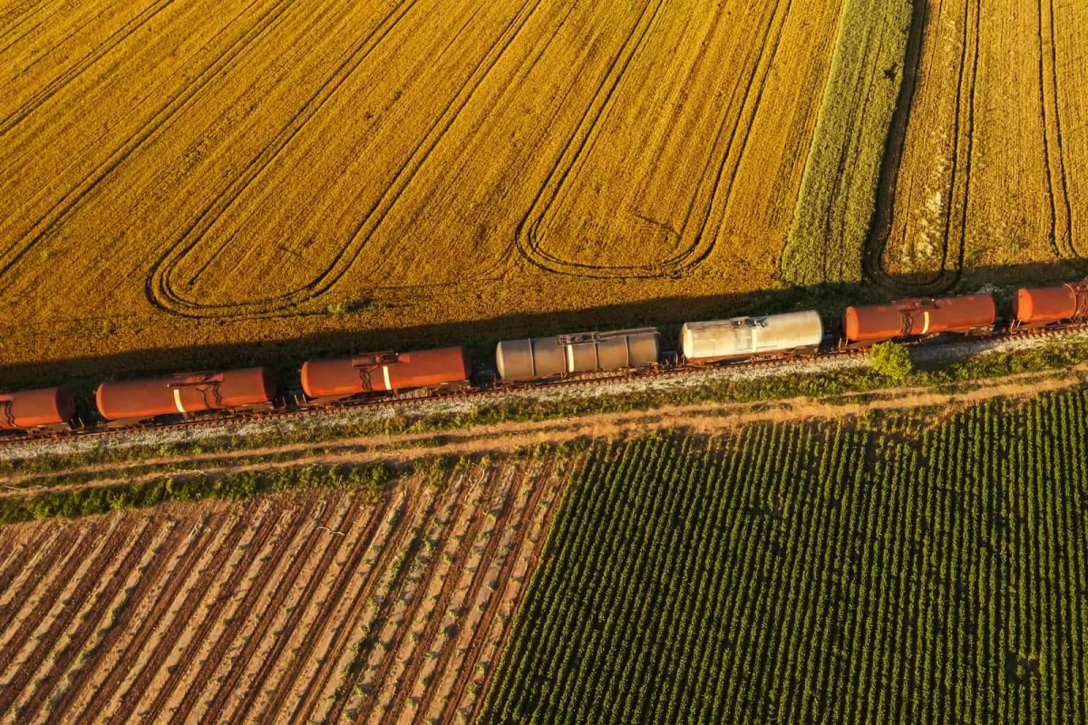 aerial view of intermodal transportation train through prairie fields