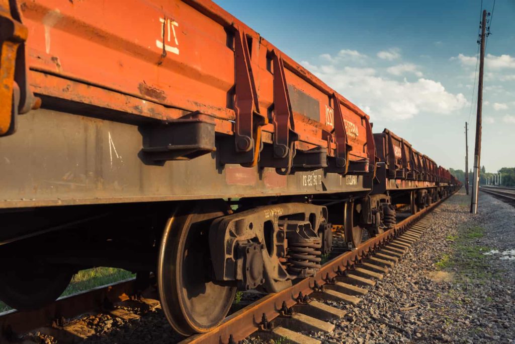 red Intermodal cargo container on train tracks