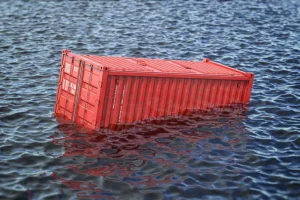 red intermodal rail container floating in the ocean or sea