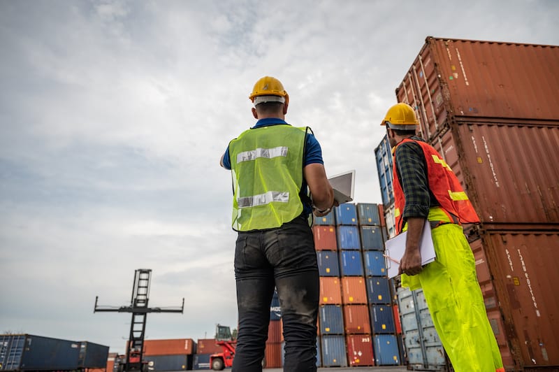 port employees counting and inspecting intermodal containers